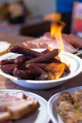 Meat snacks and burning sausages. Sausages and fire.