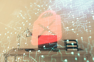 Lock sign hologram with desktop office background. Double exposure. Concept of network protection