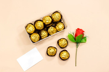 box of golden premium chocolate sweets with  empty card, rose flower for valentine's, mother's  holiday