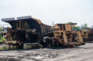 Fototapeta premium remains of old quarry trucks and machinery on junk yard