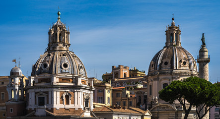 Fototapeta na wymiar The view on dome of the Santa Maria di Loreto church and dome of the Church of the Most Holy Name of Mary at the Trajan Forum. The view from Victor Emmanuel II National Monument in Rome.