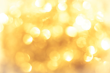 golden color blurred abstract background. yellow bokeh christmas blurred beautiful shiny Christmas...