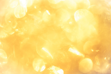 golden color blurred abstract background. yellow bokeh christmas blurred beautiful shiny Christmas...
