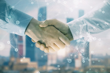 Fototapeta na wymiar Double exposure of abstract technology drawing on cityscape background with two businessmen handshake. Concept of tech role in business