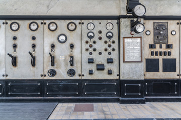 Dials and switches in the control room in old power plant. Control panel with measuring instruments