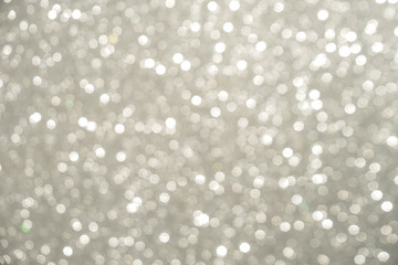 Silver Sparkling Lights Festive background with texture. Abstract Christmas twinkled bright bokeh defocused and Falling stars. Winter Card or invitation	