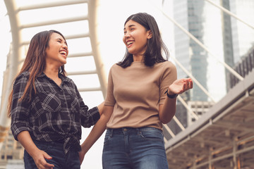 Multicultural Asian girlfriends having social time together on city holiday vacation - Best friends socialising while walking in urban environment