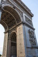 Fototapeta na wymiar A fragment of the south facade of the Arc de Triomphe de l'Étoile with the Le Départ de 1792 (or La Marseillaise) sculpture group and engravings on the pillar
