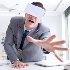 Businessman with virtual reality glasses in modern technology co