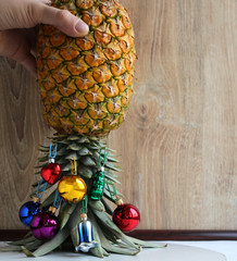 Original Christmas tree concept. Various colorful shiny glass Christmas balls hangs on the leaves...
