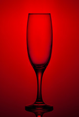 Glass goblet shot on a red background close-up