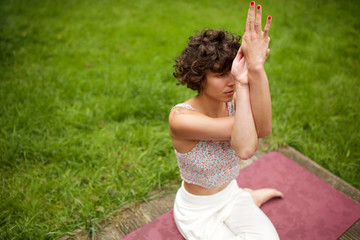 Naklejka na ściany i meble woman in yoga pose in park