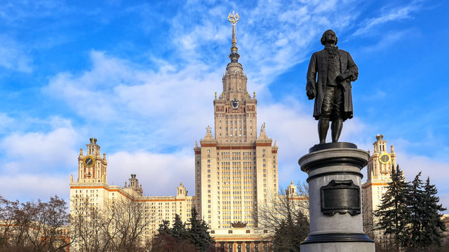 Main building and Lomonosov monument in autumn sunset campus of Moscow university under nice blue sky