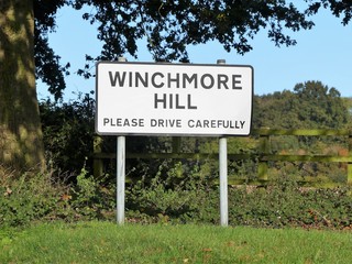 Sign for the Buckinghamshire village of Winchmore Hill with request to please drive carefully. Located at the junction of Coleshill Lane and Sampsons Hill.