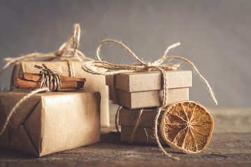 Christmas and zero waste, eco friendly packaging. Woman is wrapping gifts in craft paper on a...