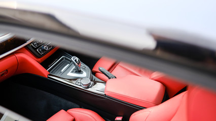 Cockpit view of an expensive German sports coupe showing the red leather interior.