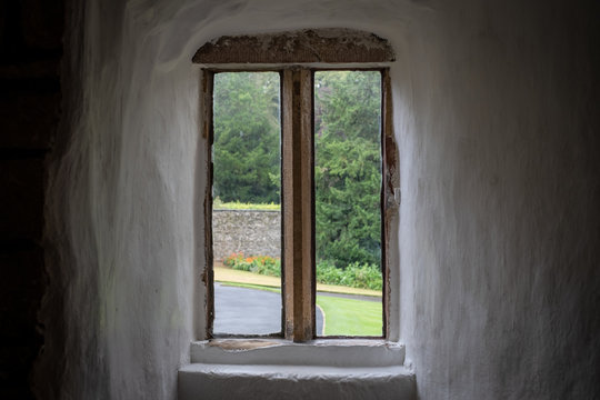 Atmospheric view of the interior of a medieval building, looking out to the private grounds below. The renovated pasture is clearly visible within.