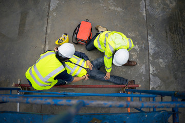 Basic first aid training for support accident in site work, Builder accident fall scaffolding to the floor, Safety team help employee accident.