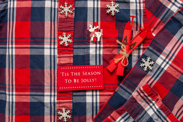 Christmas ski decor on the background of a man's shirt in a bright cage.