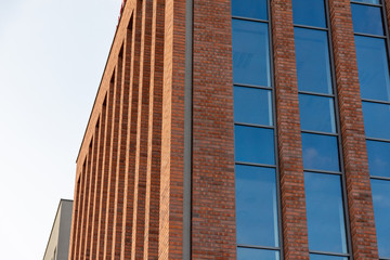 A modern brick building. Oblong windows. Text space