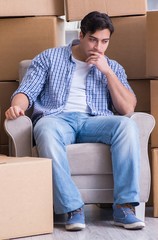 Young man moving in to new house with boxes