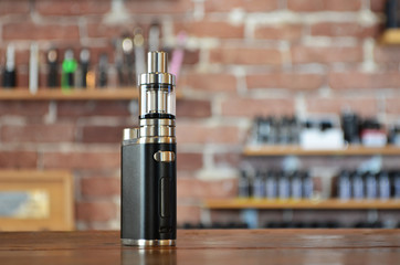 Electronic cigarette on a background of vape shop. E-cigarette for vaping.