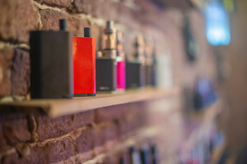 Electronic cigarette on a background of vape shop. E-cigarette for vaping.