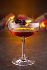 Manhattan cocktail on fireplace background