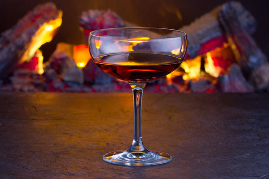 Manhattan cocktail on fireplace background