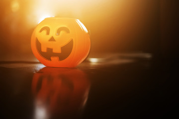 Halloween pumpkin head with golden light in dark night bakckground. Halloween holiday concept.