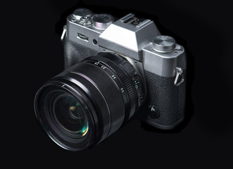 Fototapeta premium Mirrorless camera on a black background.