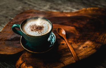 cup of coffee and beans on wooden table