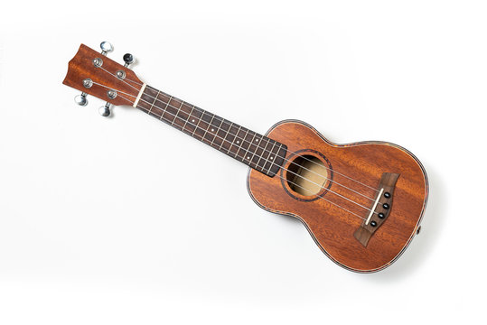 Wooden ukulele, white background. Top view.