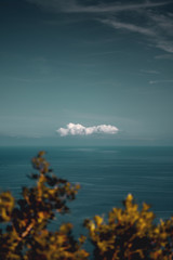 Single minimal cloud on the horizon with nature plants. Road trip on the balearic Island Mallorca, Spain