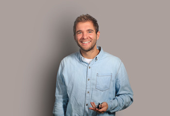 Young man in denim shirt is smiling