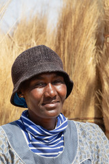 African woman carry grass