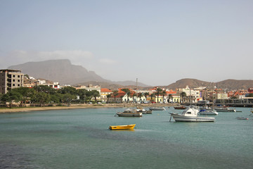 Harbor with fishing boats & the water front of Mindelo on Sao Vicente Island, Cape Verde Islands.