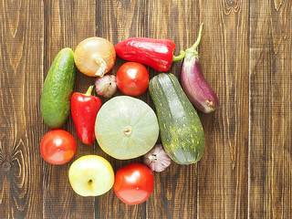 Healthy eating background. Food pictures of various fruits and vegetables isolated on wooden background.