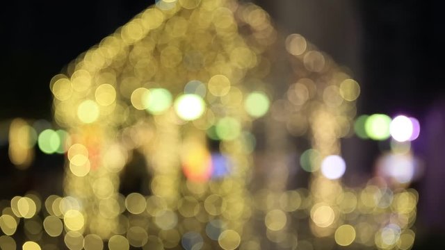 Abstract defocused blurred bokeh image of lit up gazebo with many lights