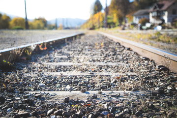 Sustainable traveling by train: Rail track and colorful, idyllic landscape in fall.
