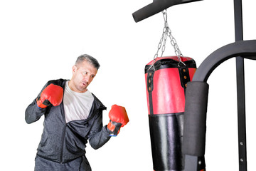 Caucasian man hitting on a boxing bag