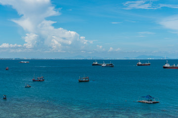 Fishing boats floating in the sea with blue sky