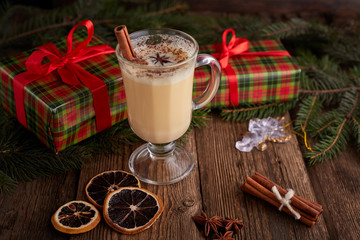 Traditional Homemade Winter Eggnog Cocktail with Whipped Cream and Cinnamon for Christmas Eve and Winter Holidays. Selective Focus. Copy Space. Toned image.