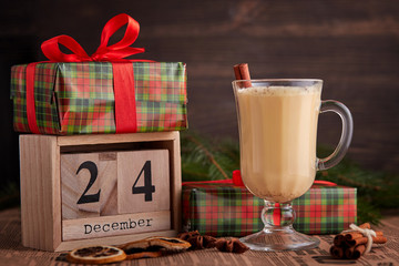 Traditional Homemade Winter Eggnog Cocktail with Whipped Cream and Cinnamon for Christmas Eve and Winter Holidays. Selective Focus. Copy Space. Toned image.