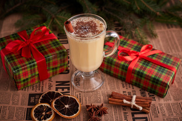 Traditional Homemade Winter Eggnog Cocktail with Whipped Cream and Cinnamon for Christmas Eve and Winter Holidays. Selective Focus. Copy Space. Toned image.