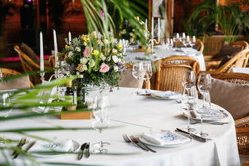 catering at a top event, glasses and flowers on the table, preparation for a significant event, beautiful dishes and glasses on the table, New Year's holiday table