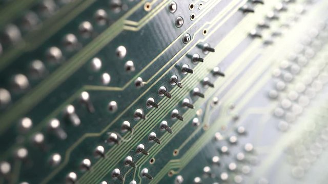 Circuit board. Printed circuit board surface, extreme close up. Electronic technology background. Dolly shot, sliding camera move and selective focus 4k footage.