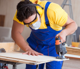 Young repairman carpenter working with a circular saw