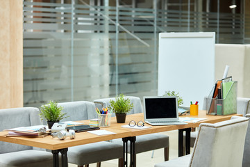 Modern brightly lighted office, Beautiful comfortable empty room for designers, long table full of...