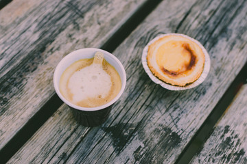 Takeaway coffee cup on a wooden table.